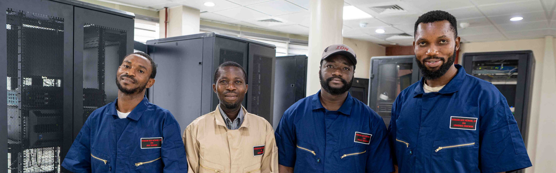 Smiling men standing in front of server